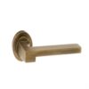 Atlantic Handles Ginevra Forme Designer Lever on Contempo Round Rose in a Yester Bronze Finish Pair of Door Handles